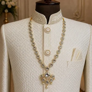 Royal pearl groom necklace with layered pearl-style beads and ornamental pendant displayed on a maroon sherwani
